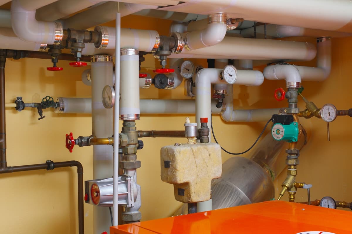 A domestic gas boiler being serviced by an engineer