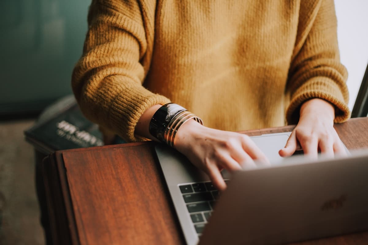 A person completing an online registration form on a laptop
