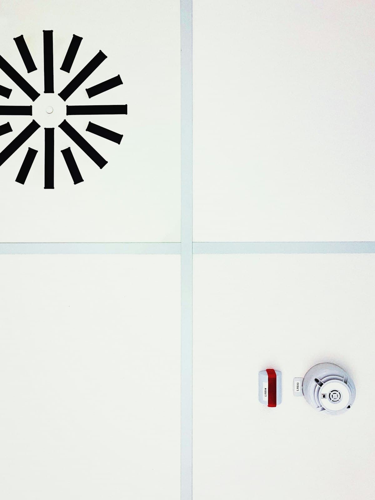 A smoke alarm mounted on a ceiling